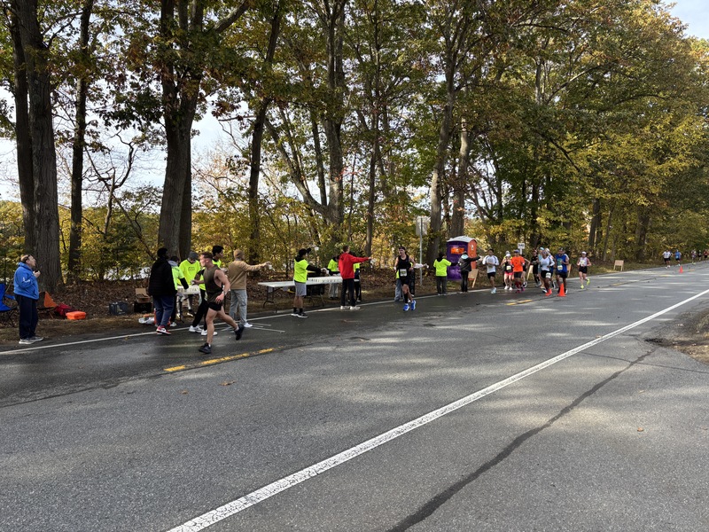 Picture of student volunteers passing out water to racers
