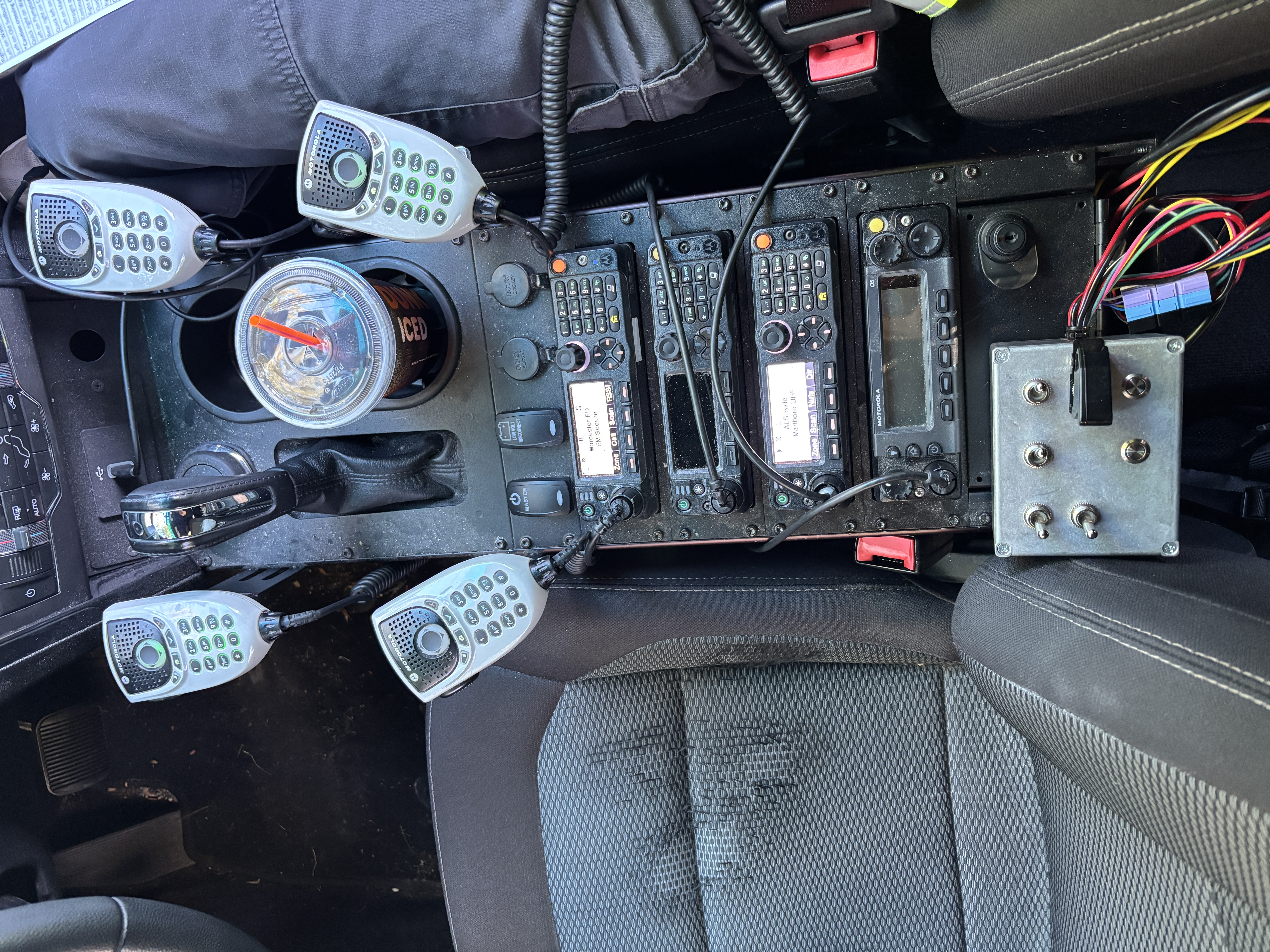 A picture of the center console of NM1B's car with four radios